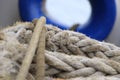 A shot of a rope with a blue ship window on the background Royalty Free Stock Photo