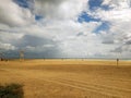 Shot of the sandy beach with several human silhouettes in Fuerteventura, Spain