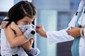 I'd rather be at the park. Shot of a scared little girl getting a vaccination in a hospital. Royalty Free Stock Photo