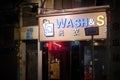 Shot of self-served laundry shop banner at night, in Kowloon City, Hong Kong