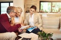 Its time to enjoy the fruits of our labor. Shot of a senior couple getting advice from their financial consultant. Royalty Free Stock Photo