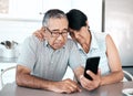 She supports me through my struggles. Shot of a senior couple looking unhappy while using a phone at home. Royalty Free Stock Photo