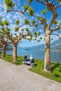 Shot of a senior couple sitting on a bench in the park in Villa Melzi near Bellagio at the famous Italian lake Como