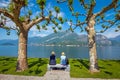 Shot of a senior couple sitting on a bench in the park in Villa Melzi near Bellagio at the famous Italian lake Como