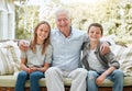 Im the luckiest grandpa in the world. Shot of a senior man sitting outside with his two grandchildren. Royalty Free Stock Photo