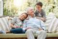 My grandchildren mean the world to me. Shot of a senior man sitting outside with his two grandchildren. Royalty Free Stock Photo