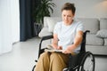 Shot of a senior woman sitting in a wheelchair and reading book at home Royalty Free Stock Photo