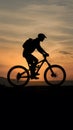 shot Silhouette of a man on mountain bike at sunset photo Royalty Free Stock Photo