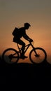 shot Silhouette of a man on mountain bike at sunset photo Royalty Free Stock Photo