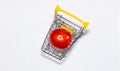 Shot of a single tomato in shopping cart isolated on white background. Ripe tasty red tomatos in shopping cart. Top view. Copy Royalty Free Stock Photo