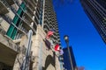 A shot of the skyscrapers with balconies in the skyline with and American flag flying with a tall black light post Royalty Free Stock Photo