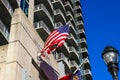 A shot of the skyscrapers with balconies in the skyline with and American flag flying with a tall black light post Royalty Free Stock Photo