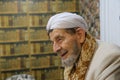 Shot of a smiling elderly muslim man who wears traditional islamic clothes