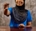 Enjoy your stay. Shot of a smiling muslim thai woman standing at a hotel reception handing over a room key. Royalty Free Stock Photo