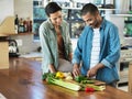 Youve got some mean dicing skills. Shot of a smiling young couple preparing a meal together in their kitchen. Royalty Free Stock Photo