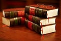 Get to know your rights. Shot of a stack of legal books and a pair of glasses on a table in a study. Royalty Free Stock Photo