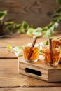 Shot with strong alcohol and cinnamon on a wooden table Royalty Free Stock Photo