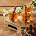 Shot with strong alcohol and cinnamon on a wooden table Royalty Free Stock Photo