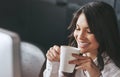 Now this is what success tastes like. Shot of a successful young businesswoman enjoying a beverage at work.