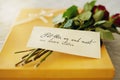 Say I love you with a romantic surprise. Shot of a surprise gift and bouquet with a note attached to it.