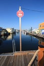 A shot taken of the ferry stop at a pier by float homes in a harbour.