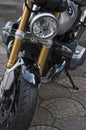 Portrait of a detail of a Bmw r nineT with a zoom on the front headlight