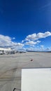 A shot of the tarmac at the Ontario International Airport with planes and runways, blue sky and clouds in Ontario California Royalty Free Stock Photo