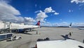 A shot of the tarmac at the Ontario International Airport with planes and runways, blue sky and clouds in Ontario California Royalty Free Stock Photo