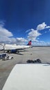 A shot of the tarmac at the Ontario International Airport with planes and runways, blue sky and clouds in Ontario California Royalty Free Stock Photo