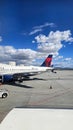 A shot of the tarmac at the Ontario International Airport with planes and runways, blue sky and clouds in Ontario California Royalty Free Stock Photo