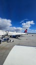 A shot of the tarmac at the Ontario International Airport with planes and runways, blue sky and clouds in Ontario California Royalty Free Stock Photo