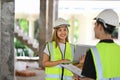 Shot of team of specialists wearing hardhat talking and walk in construction site. Building construction collaboration