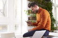 Casual businessman text messaging and using laptop while sitting at office and working Royalty Free Stock Photo