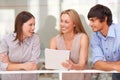 Putting their heads together. Shot of three business professionals standing and going through some paperwork together. Royalty Free Stock Photo