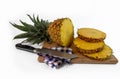 Pineapple cut with slices and knife on a chopping board Royalty Free Stock Photo