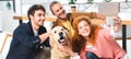 Shot of three smiling friends taking selfie with cute golden retriever Royalty Free Stock Photo
