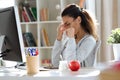 Tired young business woman having headache while working with computer in the office Royalty Free Stock Photo