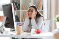 Tired young business woman having headache while working with computer in the office Royalty Free Stock Photo