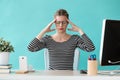 Tired young business woman having headache while working with computer in the office Royalty Free Stock Photo