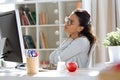 Tired young business woman having neck and back pain while working with computer in the office Royalty Free Stock Photo