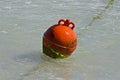 Round red buoy riding the sea waves Royalty Free Stock Photo