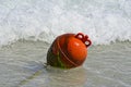 Round red buoy riding the sea waves Royalty Free Stock Photo