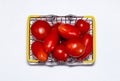 Shot of tomatoes in shopping basket isolated on white background. Ripe tasty red tomatos in shopping basket. Top view Royalty Free Stock Photo