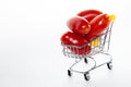 Shot of tomatoes in shopping cart isolated on white background. Ripe tasty red tomatos in shopping cart. High angle shot. Copy Royalty Free Stock Photo