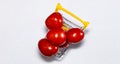 Shot of tomatoes in shopping cart isolated on white background. Ripe tasty red tomatos in shopping cart. Top view Copy space Royalty Free Stock Photo