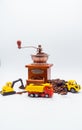 A toy excavator loads coffee beans into the back of a toy truck with a bucket, and a toy bulldozer rakes roasted coffee beans into Royalty Free Stock Photo