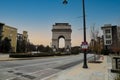 A shot of the Triumphal arch at the Millennium Gate Museum with African Americans underneath surrounded by buildings