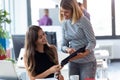 Two business young women working together with digital tablet in the modern startup office Royalty Free Stock Photo