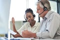 I dont understand how this works. Shot of two call centre agents sitting together in the office and having a discussion. Royalty Free Stock Photo