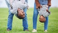 Do anything, but let it produce joy. Shot of two children hanging upside down by their parents outside. Royalty Free Stock Photo